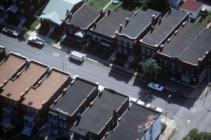 urban housing in Missouri pictured from above showing dark coloured buildings and roofs with very little green infrastructure